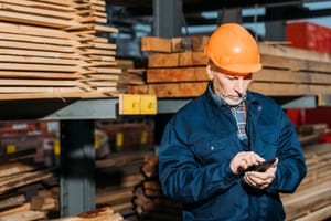 senior-builder-in-helmet-using-smartphone-outside-2021-08-31-03-43-24-utc.jpg