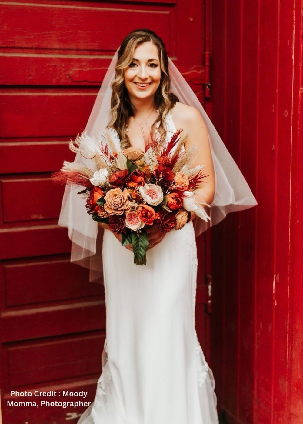 Bride holding a custom burgundy and rust sola wood wedding bouquet in Frederick, Maryland