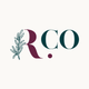 Rosemary Collective logo that reads "R.co". The R is made partially of a rosemary sprig