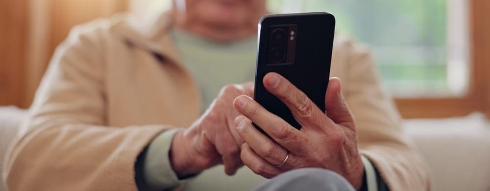 Elderly couple using phone to create will