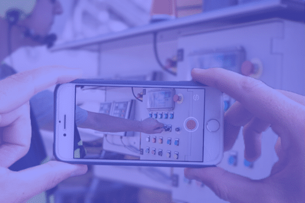 a person filming a male engineer